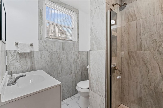 full bathroom featuring toilet, marble finish floor, a shower stall, and vanity