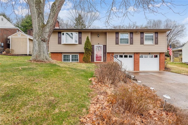 split foyer home featuring a garage, driveway, brick siding, and a front lawn