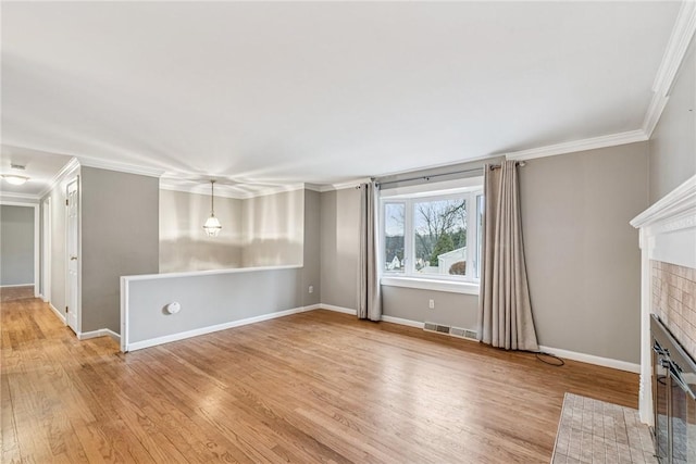 unfurnished living room with visible vents, a fireplace, light wood-style flooring, and crown molding