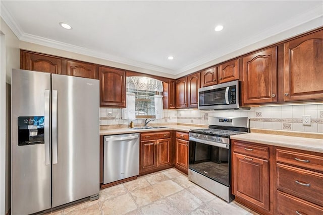 kitchen featuring light countertops, appliances with stainless steel finishes, backsplash, and a sink