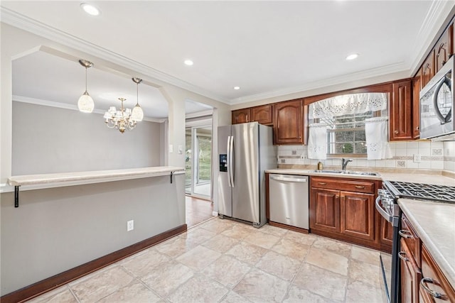 kitchen featuring a wealth of natural light, appliances with stainless steel finishes, light countertops, and a sink