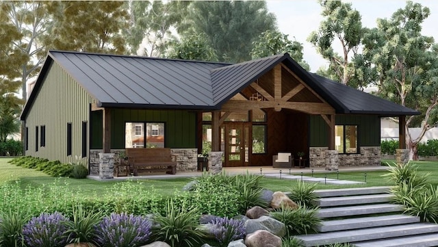 back of house with stone siding, a standing seam roof, and metal roof