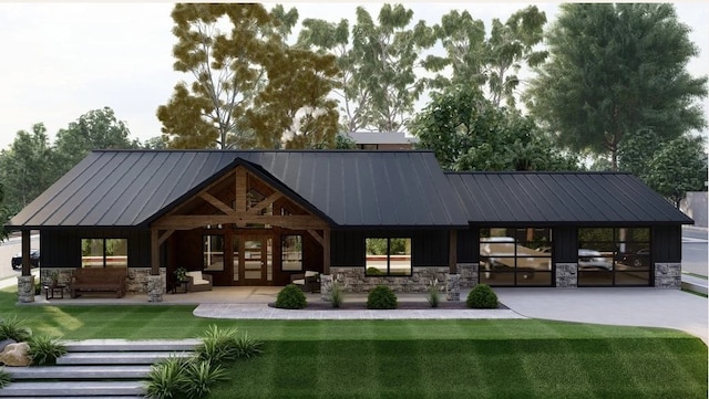 rear view of property featuring metal roof, stone siding, a standing seam roof, and a lawn