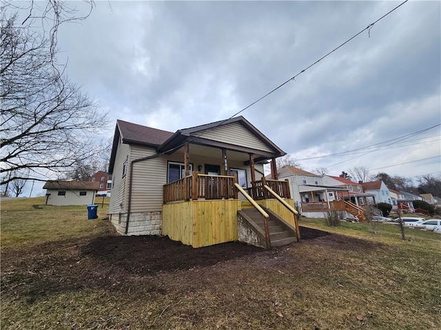 back of house featuring a residential view, roof with shingles, and stairway