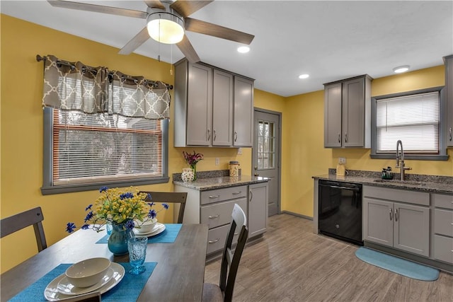 kitchen with dishwasher, gray cabinets, and a sink