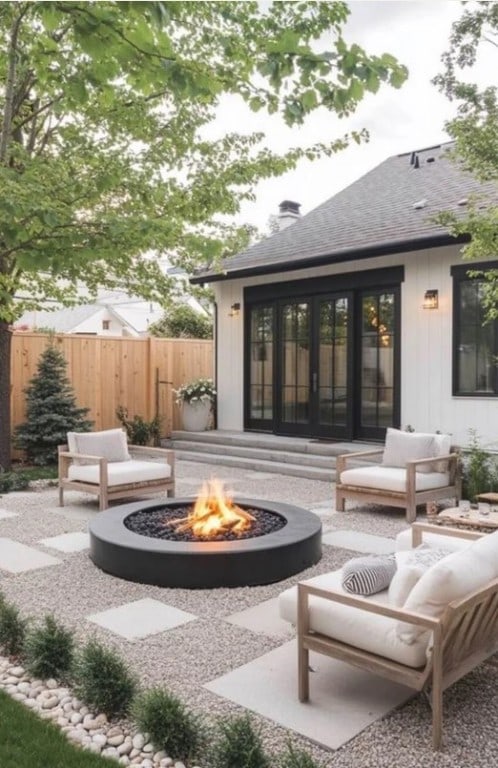 back of house featuring an outdoor living space with a fire pit, a shingled roof, a patio area, and fence