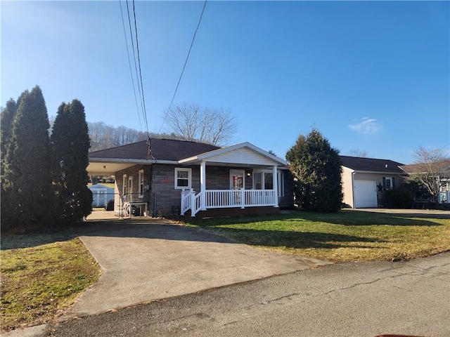 single story home with a porch, a front yard, stone siding, and driveway