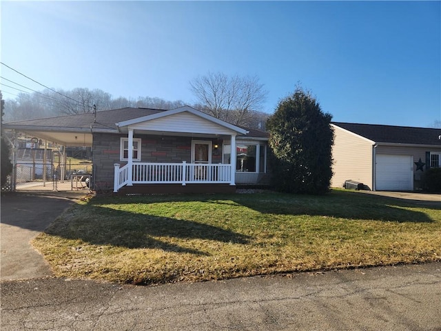 ranch-style home with an attached carport, covered porch, a front lawn, and concrete driveway