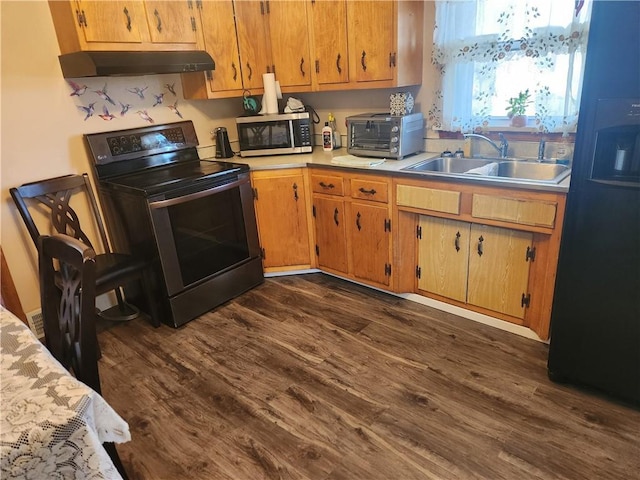 kitchen with a toaster, stainless steel appliances, light countertops, under cabinet range hood, and a sink