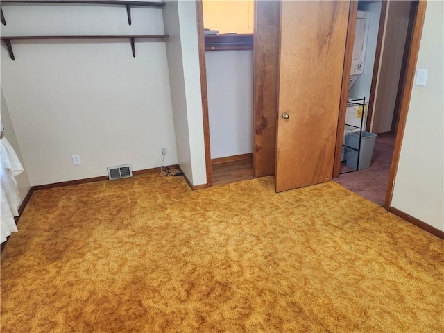 unfurnished bedroom featuring carpet, visible vents, and baseboards