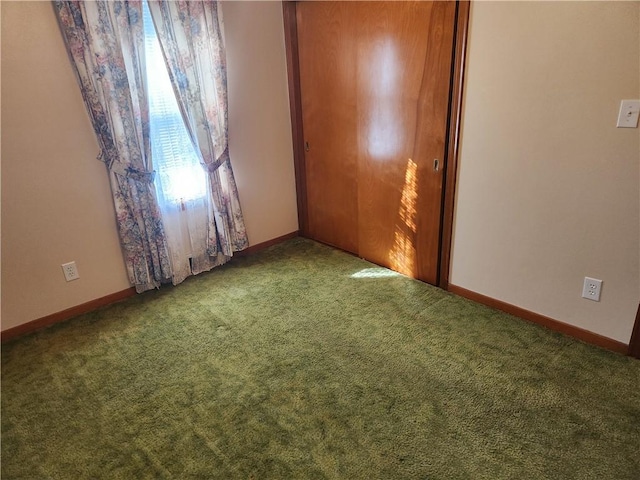 unfurnished bedroom featuring a closet, baseboards, and carpet flooring