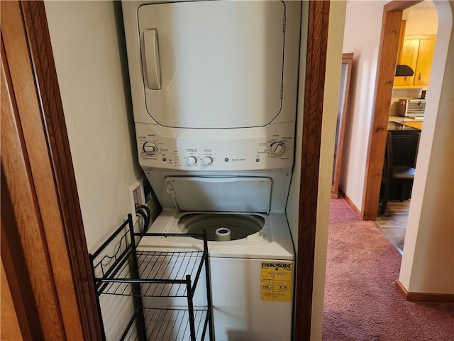 washroom with stacked washing maching and dryer, carpet, baseboards, and arched walkways