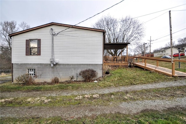 view of side of home featuring a deck and an attached carport