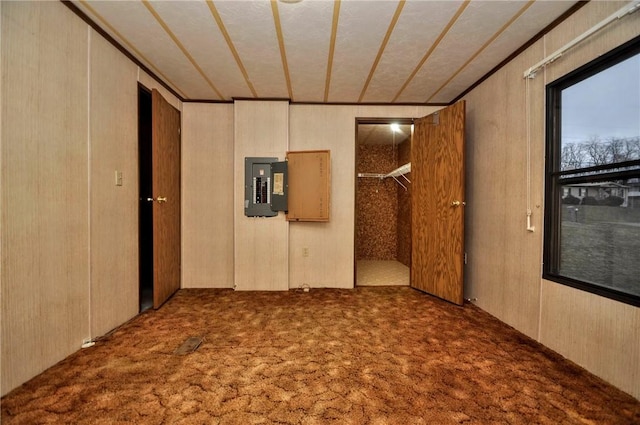 carpeted empty room featuring electric panel