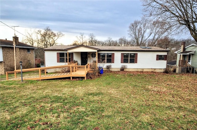 rear view of property with a lawn and a deck