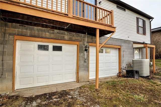 garage featuring central AC and dirt driveway