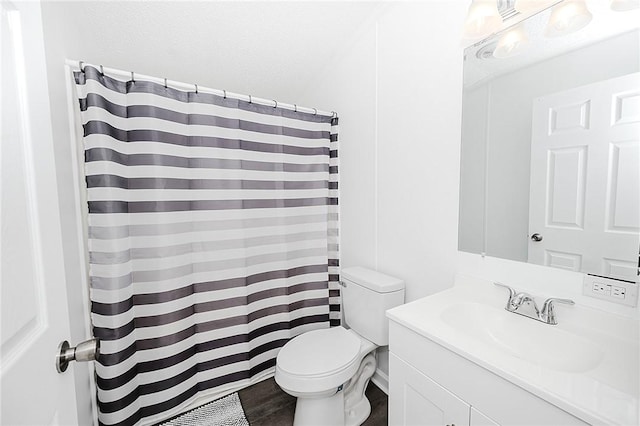 full bathroom with toilet, a shower with curtain, wood finished floors, and vanity