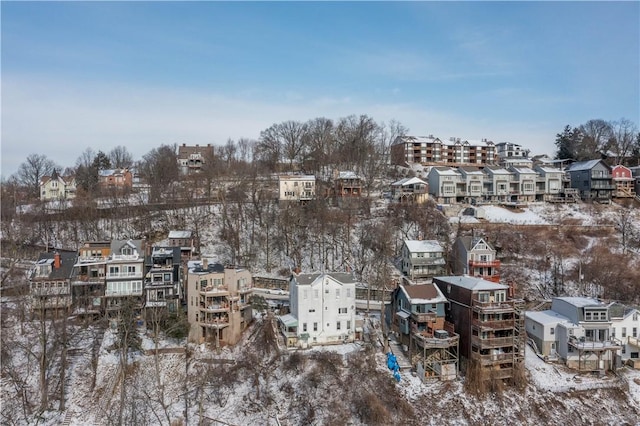 snowy aerial view with a residential view