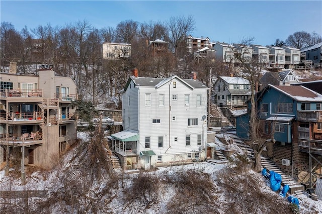 snowy aerial view with a residential view