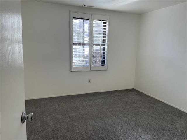 carpeted spare room with visible vents