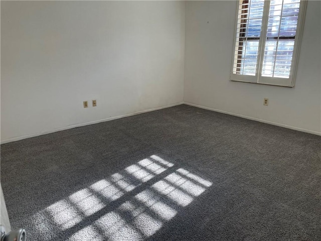 carpeted empty room with baseboards