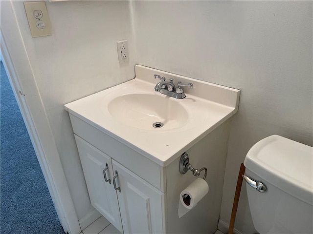 half bathroom with toilet and vanity