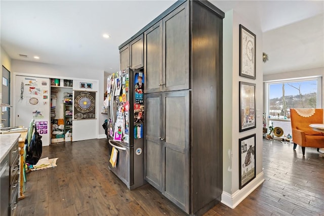 kitchen with recessed lighting, dark wood finished floors, light countertops, and freestanding refrigerator