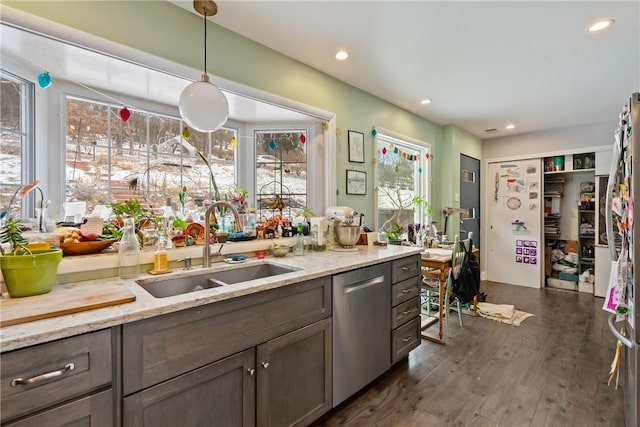 kitchen with pendant lighting, dark wood finished floors, recessed lighting, a sink, and dishwasher