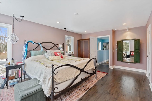 bedroom featuring dark wood-style floors, recessed lighting, a chandelier, and baseboards