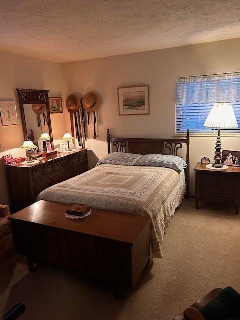 carpeted bedroom with a textured ceiling