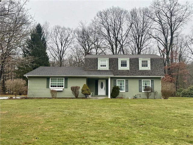 dutch colonial with a front lawn and roof with shingles