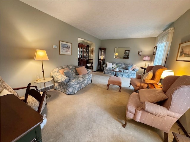 carpeted living area featuring visible vents and a textured ceiling