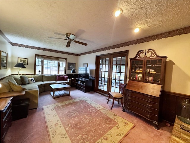 living room with light carpet, a textured ceiling, and french doors