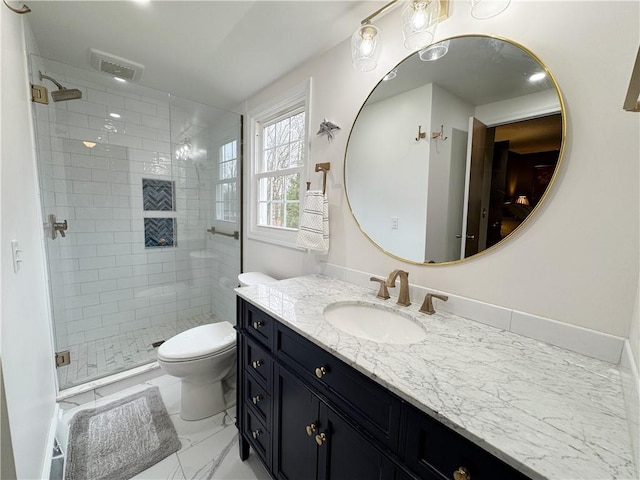 bathroom with marble finish floor, visible vents, toilet, a shower stall, and vanity