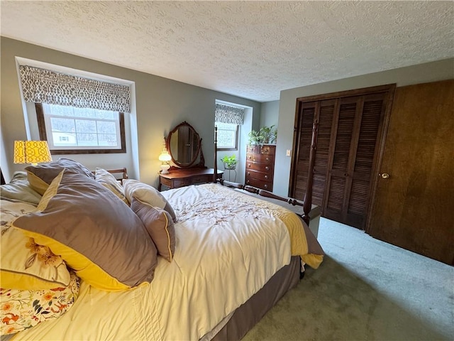 bedroom with a textured ceiling, a closet, and carpet