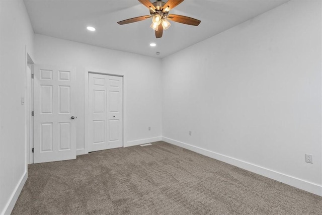 unfurnished bedroom with carpet, baseboards, a closet, and recessed lighting