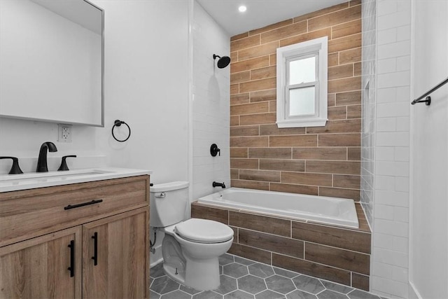 full bathroom featuring toilet, tile patterned flooring, tiled shower / bath, and vanity