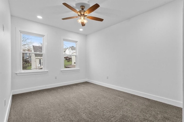 empty room featuring baseboards, dark carpet, a ceiling fan, and recessed lighting