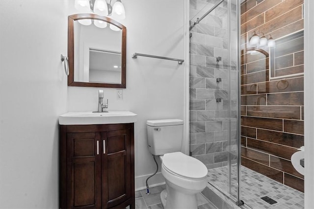 full bath featuring toilet, a stall shower, baseboards, and vanity