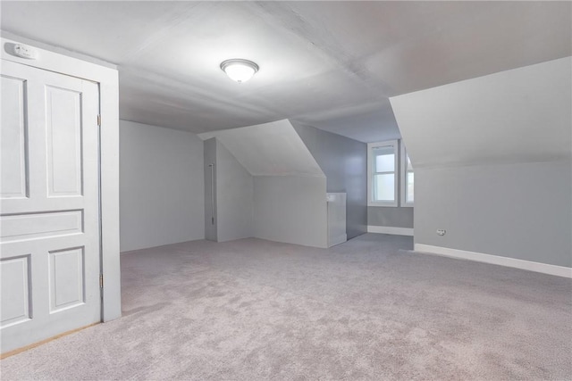 bonus room with lofted ceiling and carpet floors