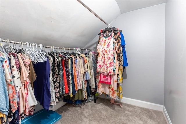 walk in closet featuring vaulted ceiling and carpet