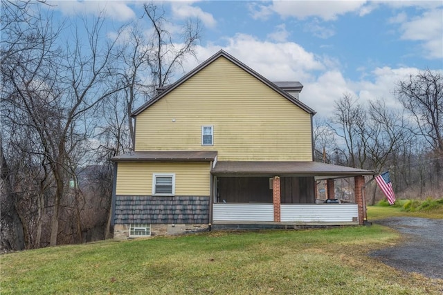 view of home's exterior featuring a yard and a sunroom