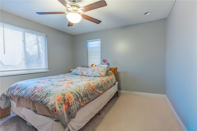 carpeted bedroom featuring a ceiling fan and baseboards