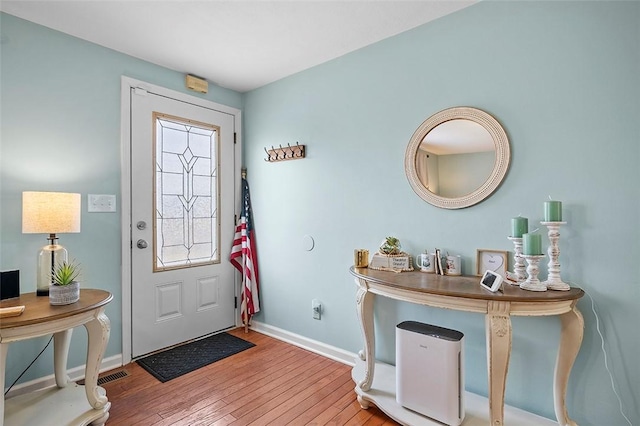 entryway featuring visible vents, baseboards, and hardwood / wood-style flooring