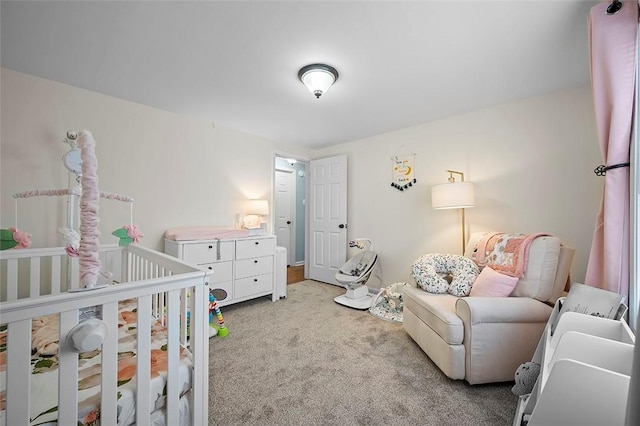 carpeted bedroom with a nursery area