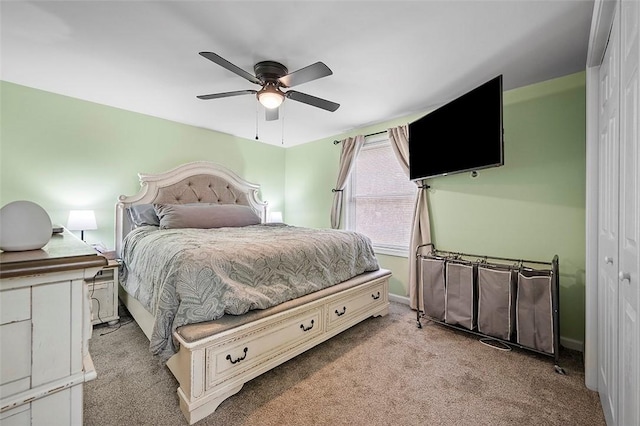 bedroom featuring ceiling fan, baseboards, and light colored carpet