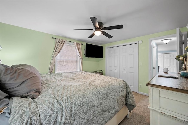 bedroom with baseboards, a ceiling fan, a closet, and light colored carpet