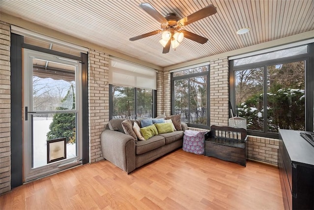 sunroom featuring wooden ceiling and ceiling fan