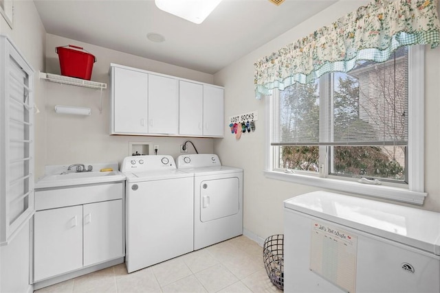 laundry room featuring light tile patterned floors, separate washer and dryer, a sink, and cabinet space