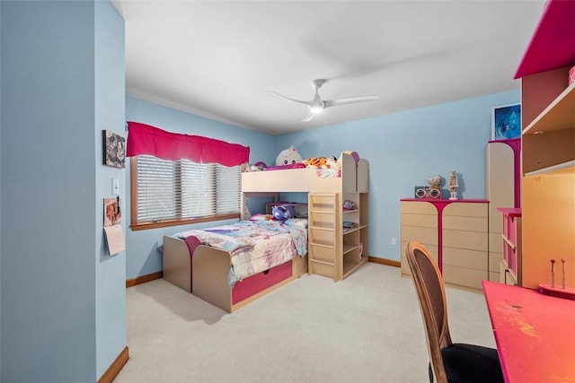 carpeted bedroom with ceiling fan and baseboards